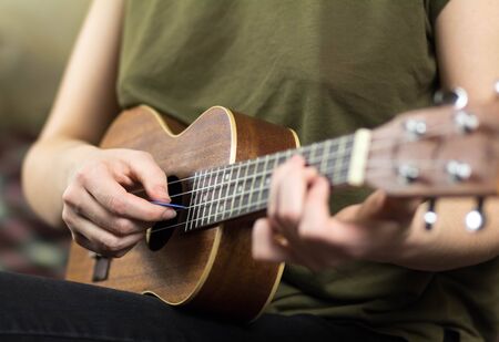 Girl playing the ukulele. Close up. Isolated on white background.の写真素材