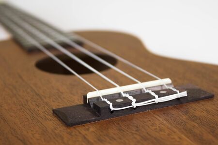 Bridge at ukulele. Close up. Isolated on white background.