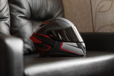 Beautiful black and red motorcycle helmet with black visor.の写真素材