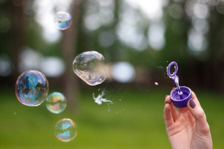 A man blows soap bubbles. Close up.の写真素材