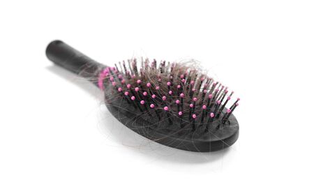Comb with the fallen hair. Close up. Isolated on a white background.の写真素材