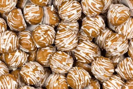Custard cookies with white chocolate icing. Lots of cookies.