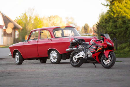 KRASNOYARSK, RUSSIA - May 10, 2020: Red sportbike Honda CBR 600 RR and retro car Moskvich 412....