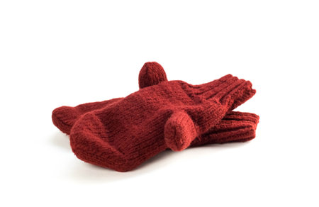 Dark red knitted mittens. Close up. Isolated on a white background.の写真素材
