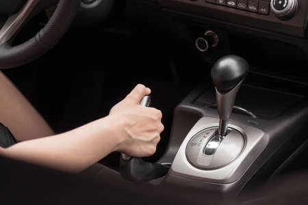 Driver pulling the hand brake in car. Close up.の写真素材