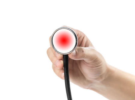 The hand holds a stethoscope. Close up. Isolated on a white background.の写真素材