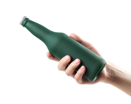 The hand holds a green frosted beer bottle. close up. isolated on a white background.の写真素材