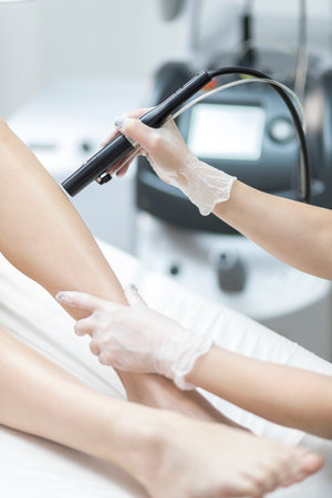 A girl at laser hair removal treatments.の写真素材