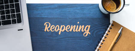 Word reopening on a desk next to a computer, a notebook, and a cup of coffee. Office scene that resumes its activity.の写真素材