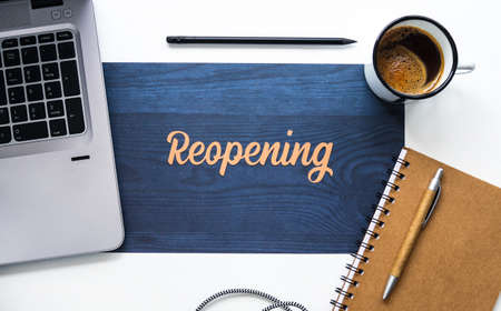 Word reopening on a desk next to a computer, a notebook, and a cup of coffee. Office scene that resumes its activity.の写真素材