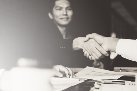 business partners handshaking after business success negotiation at meeting roomの写真素材