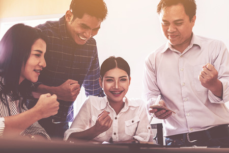 team of happy business people in smart casual wear looking at the Successful business; success and winning concept.の写真素材