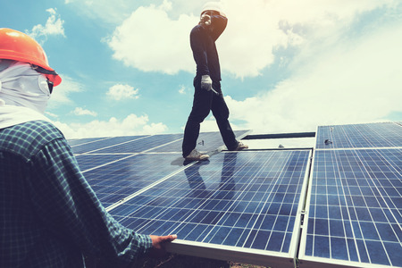 engineer team working on replacement solar panel in solar power plant;engineer and electrician team swapping and install solar panel after solar panel voltage dropの写真素材