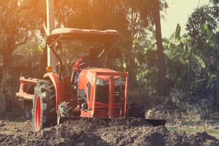 Grader leveling landfill on construction site before kick off projectの写真素材
