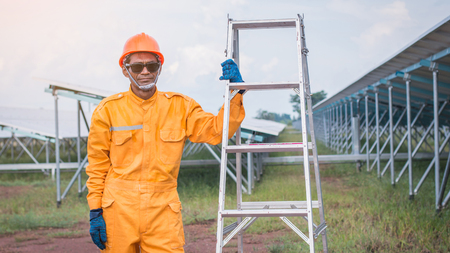 labor working on cleaning solar panel with water clean at solar power plantの写真素材