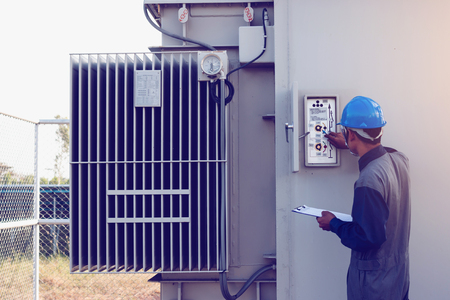 engineer or electrician working on checking and maintenance equipment at green energy solar power...