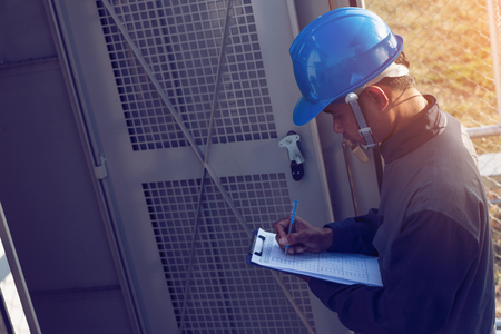 engineer or electrician working on checking and maintenance equipment at green energy solar power plant; checking status step up transformer high voltage at transformer yard
の写真素材