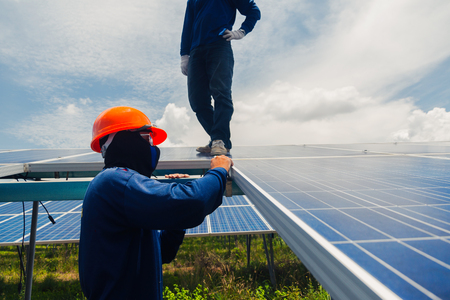 engineer team working on replacement solar panel in solar power plant;engineer and electrician team swapping and install solar panel ; electrician team checking hot spot on break panelの写真素材