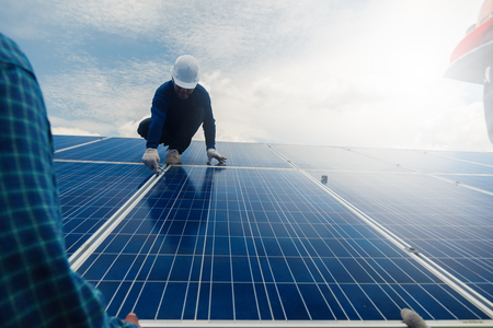 engineer team working on replacement solar panel in solar power plant;engineer and electrician team swapping and install solar panel ; electrician team checking hot spot on break panelの写真素材