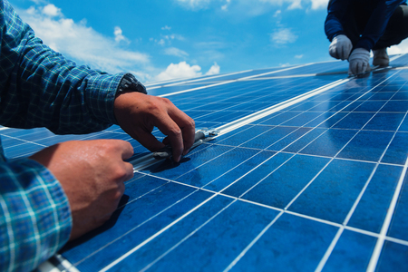 engineer team working on replacement solar panel in solar power plant;engineer and electrician team swapping and install solar panel ; electrician team checking hot spot on break panelの写真素材