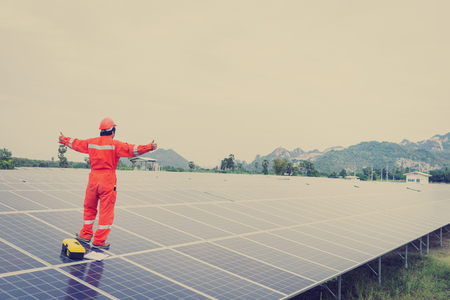 engineer in solar power plant working on installing solar panel ; operation of solar power plant by smart operatorの写真素材