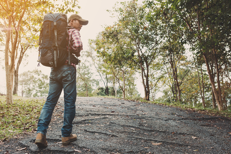 Hiking man traveling with backpack in mountainsの写真素材