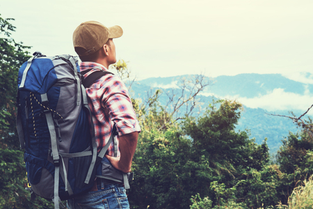 Hiking man traveling with backpack in mountainsの写真素材