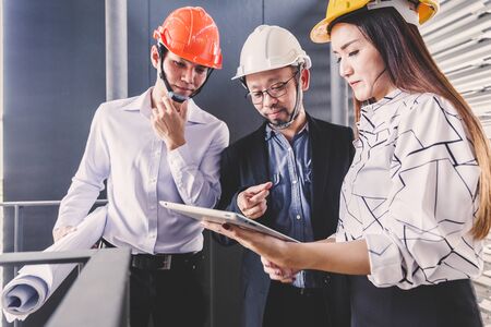Consultant engineer discussing construction project in blueprint; Consulting concept in construction