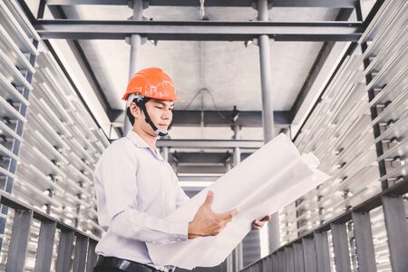 Consultant engineer discussing construction project in blueprint; Consulting concept in constructionの写真素材