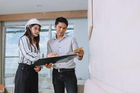 Project engineer, engineer working on blueprint architectural project at construction siteの写真素材