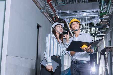 Project engineer, engineer working on blueprint architectural project at construction site