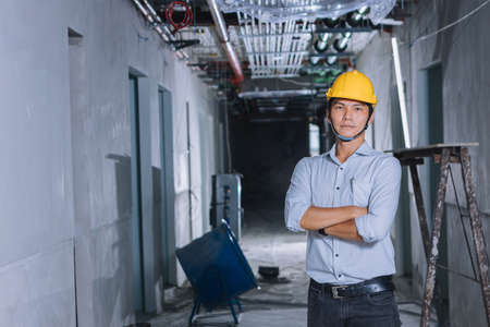 Project engineer, engineer working on blueprint architectural project at construction siteの写真素材
