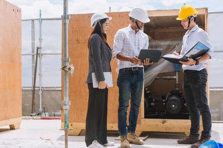 Project engineer, engineer working on blueprint architectural project at construction siteの写真素材