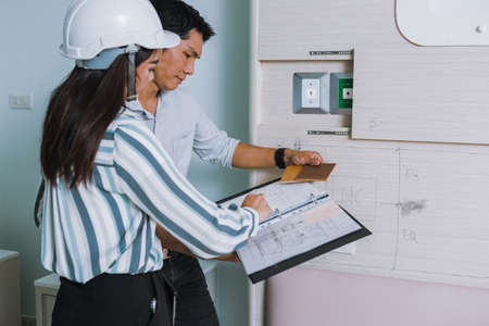 Project engineer, engineer working on blueprint architectural project at construction site