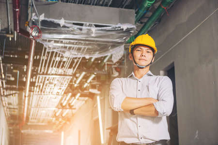Project engineer, engineer working on blueprint architectural project at construction siteの写真素材