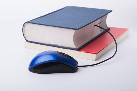 Color photo of an stack books and mouseの写真素材