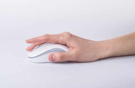 Male hand holding computer mouse isolated on whiteの写真素材