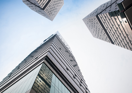 Looking up at business buildings in downtown New Yorkの写真素材