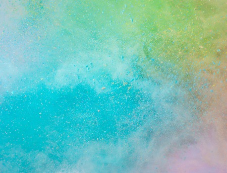 Explosion of colored powder on white backgroundの写真素材