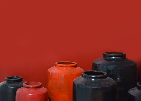 Red and black ceramic jar on red backgroundのeditorial素材