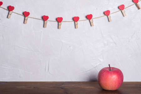 Apple on a wooden board, love shelf on the wallの写真素材