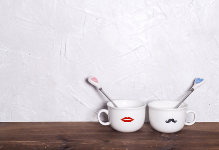 Valentine's day holiday celebration with hearts and cups over bokeh backgroundの写真素材