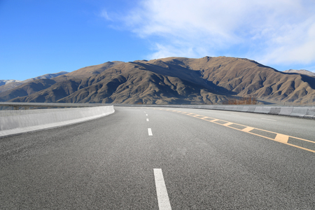 Empty highways and distant mountainsの写真素材