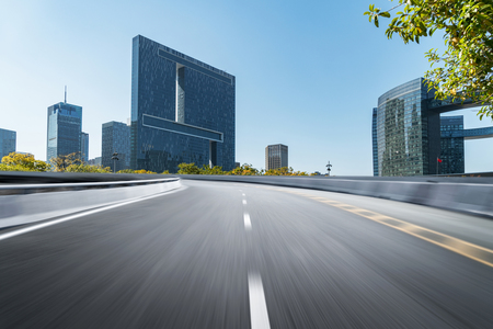 Empty road floor surface with modern city landmark buildings of hangzhou bund Skyline,zhejiang,chinaの写真素材