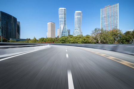 Empty road floor surface with modern city landmark buildings of hangzhou bund Skyline,zhejiang,chinaの写真素材