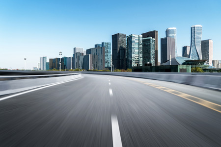 Empty road floor surface with modern city landmark buildings of hangzhou bund Skyline,zhejiang,chinaの写真素材