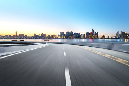 Empty road floor surface with modern city landmark buildings of hangzhou bund Skyline,zhejiang,chinaの写真素材