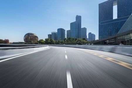 Empty road floor surface with modern city landmark buildings of hangzhou bund Skyline,zhejiang,chinaの写真素材