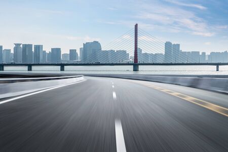 Empty road floor surface with modern city landmark buildings of hangzhou bund Skyline,zhejiang,chinaの写真素材