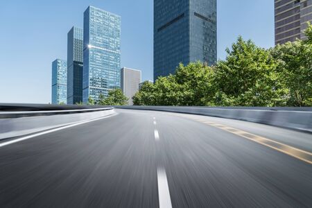 Empty road floor surface with modern city landmark buildings of hangzhou bund Skyline,zhejiang,chinaの写真素材